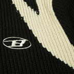 Black 2KWRLD cardigan jacket with a cozy knit texture, featuring a front button closure and ribbed cuffs.