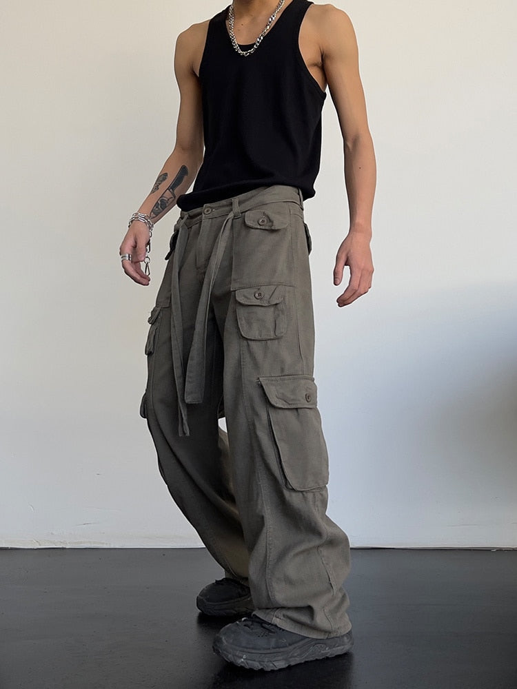 Black loose cargo pants by 2KWRLD featuring relaxed fit and multiple pockets, shown on a model.