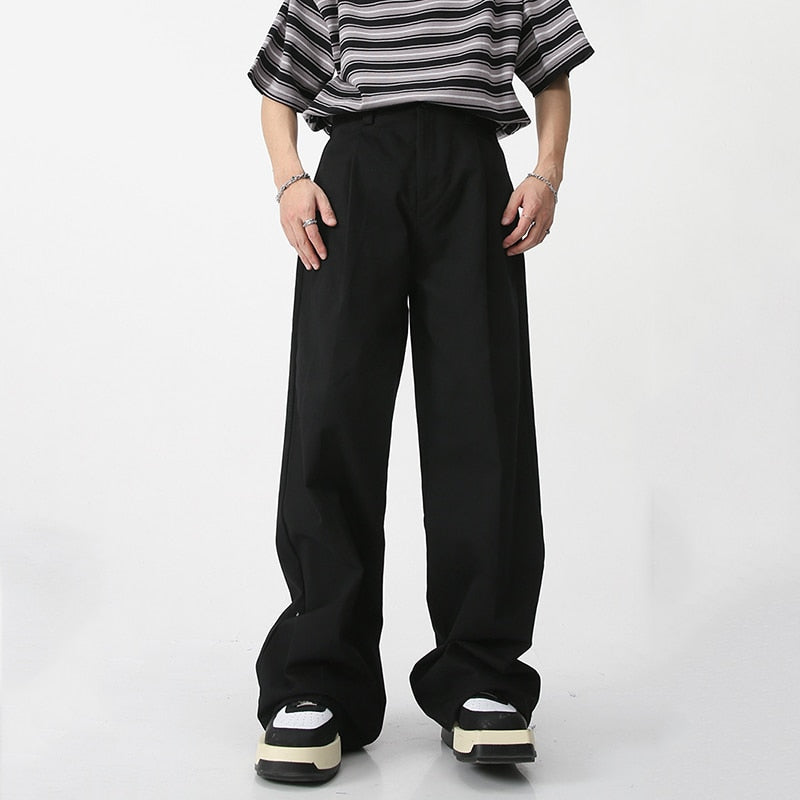 Black loose suit pants from 2KWRLD with a relaxed fit and tailored design, shown on a plain background.