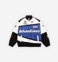 Blackaid Jacket by 2KWRLD in blue, featuring a sleek design and zip-up front, displayed on a hanger.