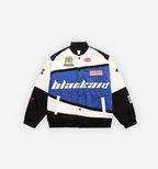 Blackaid Jacket by 2KWRLD in blue, featuring a sleek design and zip-up front, displayed on a hanger.