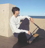 2KWRLD striped long-sleeve shirt with multicolored horizontal stripes, casual fit, and ribbed cuffs, displayed on a mannequin.