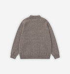 Saturn Cardigan by 2KWRLD displayed on a hanger, featuring a cozy knit fabric with a relaxed fit and button-up front design.