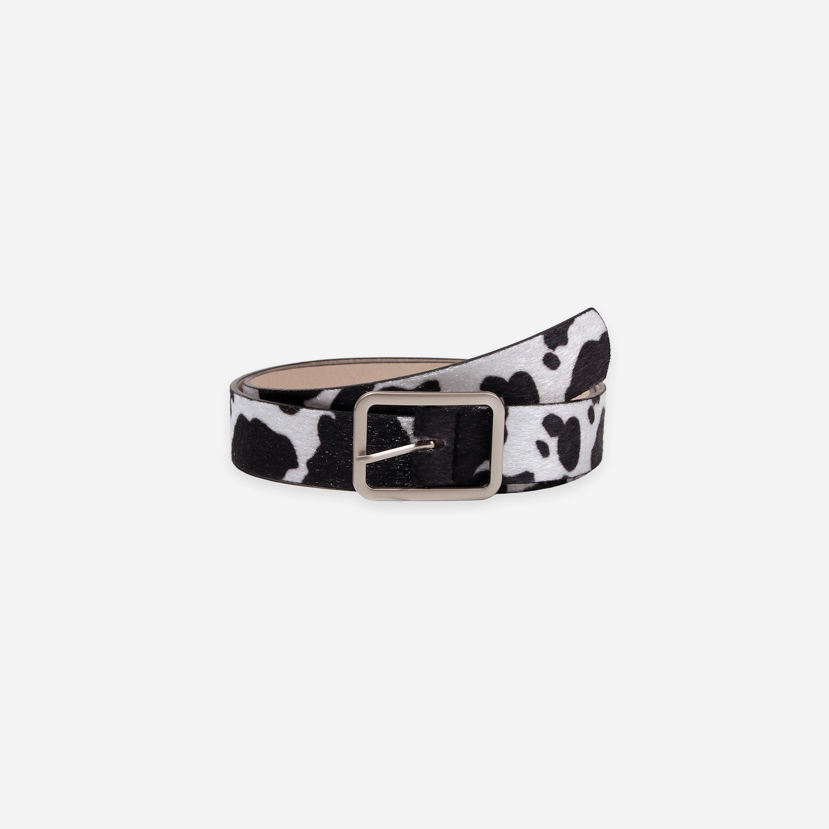 Black and white cow print belt with a silver buckle on a white background