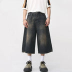 Black and grey Renegade Jorts by 2KWRLD featuring distressed denim and frayed hems, casual style for everyday wear.