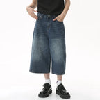 Black and grey Renegade Jorts by 2KWRLD featuring distressed denim and frayed hem, casual summer shorts for men.