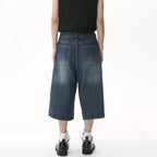 Black and grey Renegade Jorts by 2KWRLD featuring distressed denim shorts with frayed hem and casual fit.