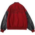 Black 2KWRLD varsity jacket with white stripe accents, ribbed cuffs, and a classic letterman style, shown on a hanger.