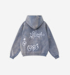 Black graffiti zip-up jacket from 2KWRLD featuring vibrant spray paint designs and a casual fit.