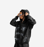 Black graffiti zip-up jacket by 2KWRLD featuring vibrant spray paint designs and a casual, streetwear style.