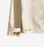 Close-up of the cuff hem of a stylish suede jacket V2 by 2K WRLD, showing detailed stitching and soft suede texture.