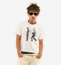 Person wearing a white t-shirt with graphic design and sunglasses on a white background