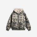 Cropped camo canvas jacket by 2KWRLD featuring a military-style print and adjustable waist on a hanger.