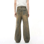 Dark blue Jungle Denim jeans from 2KWRLD with a slim fit design, displayed on a wooden hanger against a neutral background.