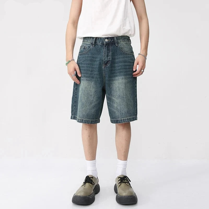 Washed denim React Jorts by 2KWRLD featuring distressed details and a relaxed fit, displayed on a neutral background.
