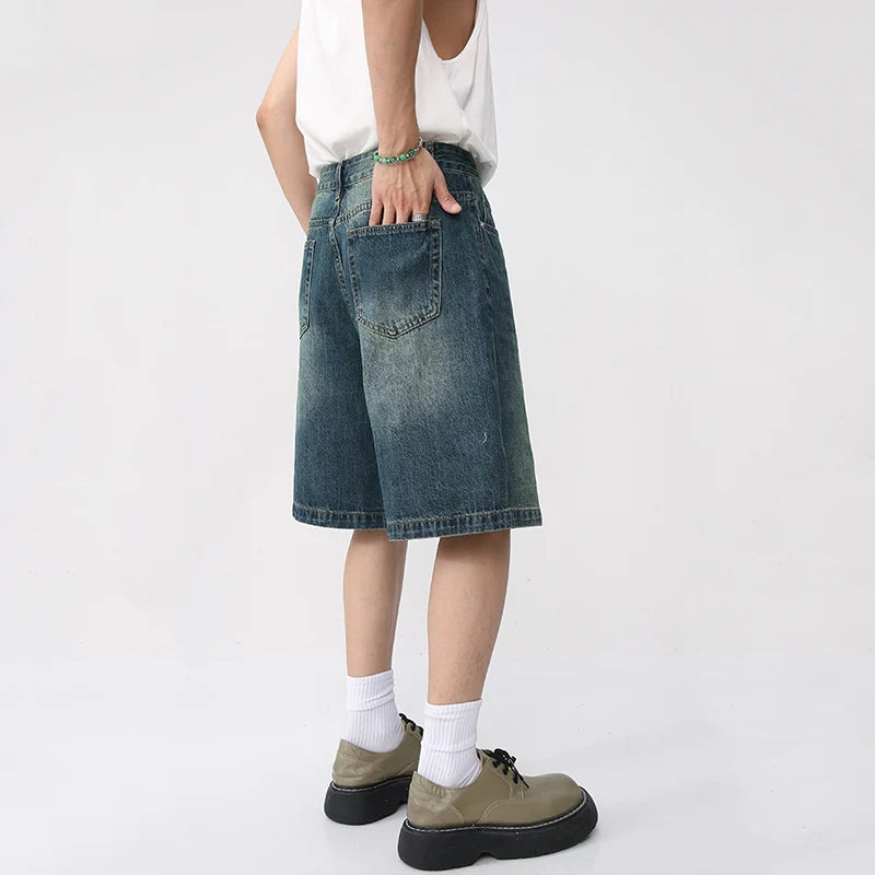 Light-wash React Jorts by 2KWRLD featuring distressed denim and frayed hems, styled as casual men's shorts.