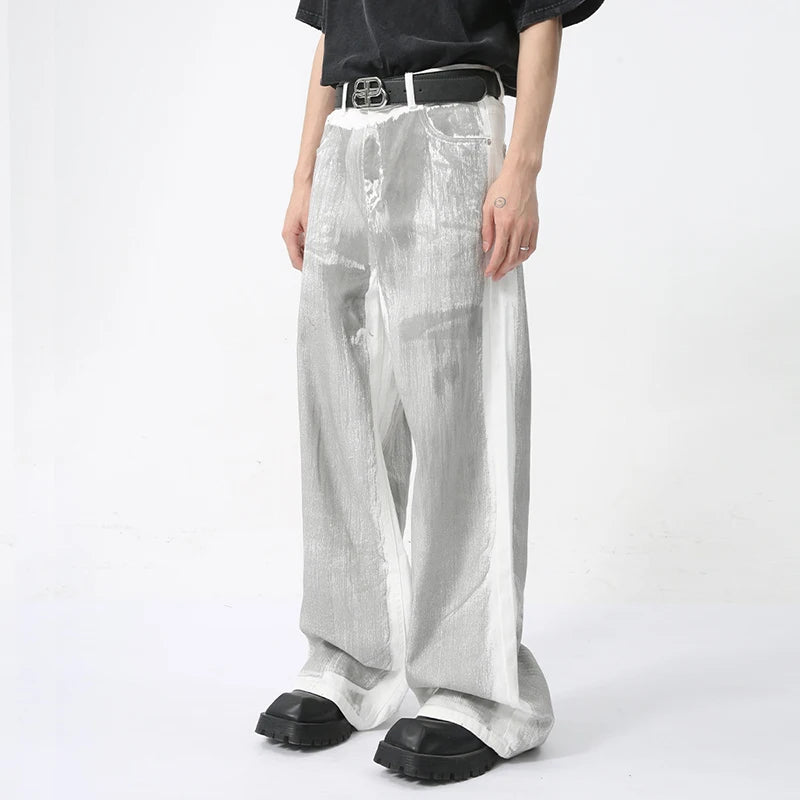 White Dirty Paint Denim jeans from 2KWRLD featuring a distressed, graffiti-inspired paint design and a slim fit style.