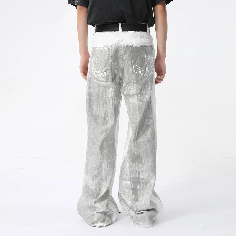 White distressed denim jeans from 2KWRLD featuring a dirty paint design, casual fit, and rugged, textured appearance.