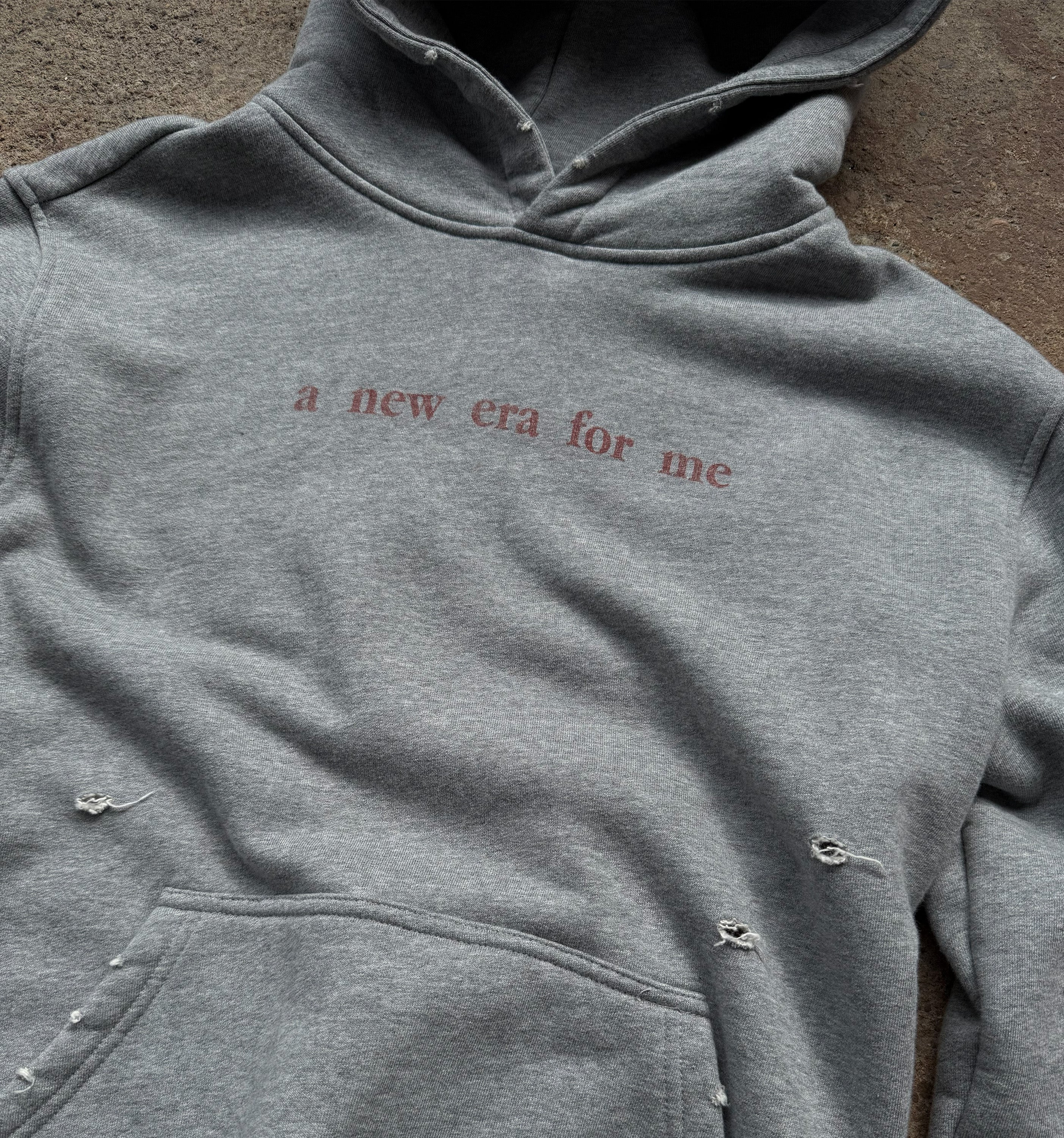 Light blue New Era For Me hoodie by 2KWRLD, featuring a relaxed fit and casual style, displayed on a hanger.