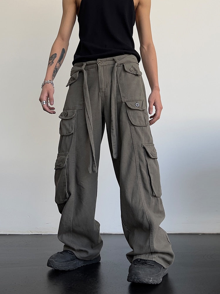 Black loose cargo pants from 2KWRLD featuring a relaxed fit and multiple pockets, ideal for casual and streetwear styles.